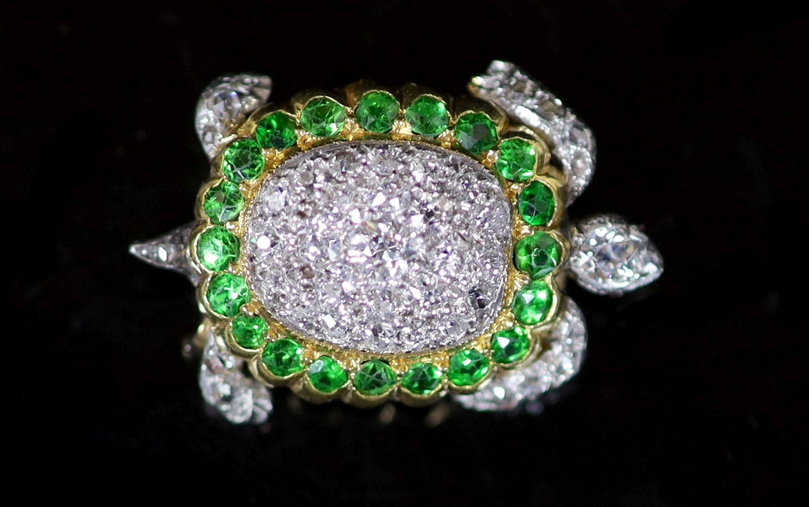 A platinum, pave set diamond and demantoid garnet set tortoise brooch